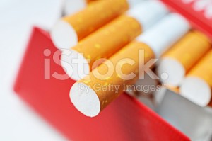 stock-photo-39960786-pack-of-cigarettes-in-red-box-with-filters-in-focus